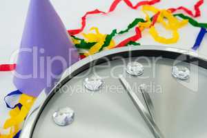 Clock and streamers against white background