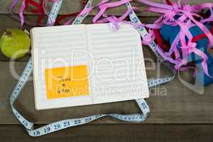 Diary with new year resolution join a gym and measuring tape