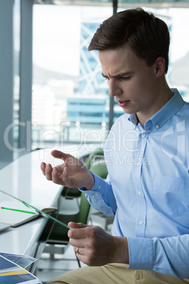 Male executive using glass digital tablet