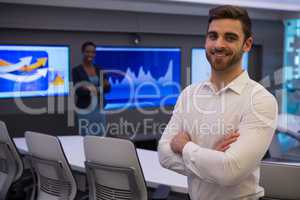 Male and female executives standing in boardroom