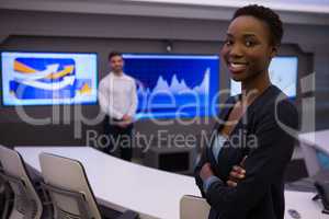 Male and female executives standing in boardroom