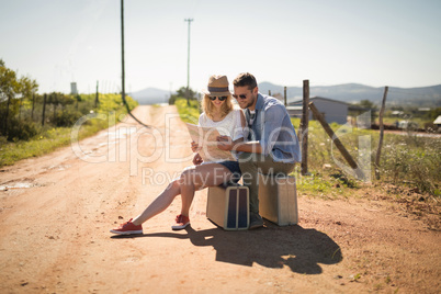 Couple looking at map on a sunny day