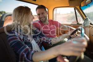 Couple sitting together in a car