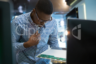 Computer engineer repairing motherboard at desk