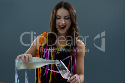 Woman pouring champagne into glass