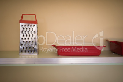 Grater and tray in the shelf