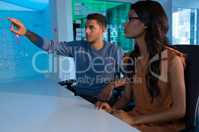 Business executives touching digital screen