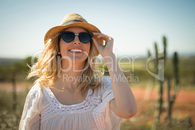 Woman in sunglasses smiling on a sunny day
