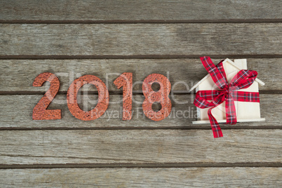 New year 2018 with gift on wooden surface