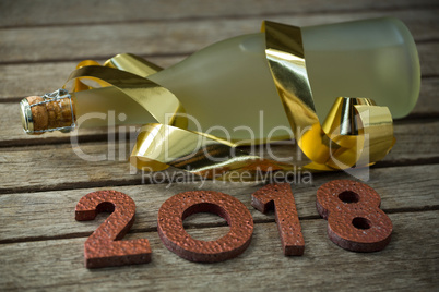 Bottle of champagne and numbers forming 2018 Year