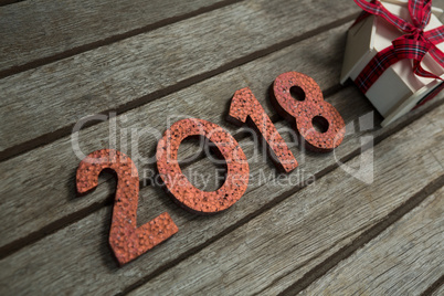 New year 2018 with gift on wooden surface