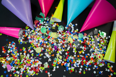 Party hat with confetti on black background