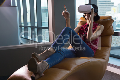 Female executive using virtual reality headset