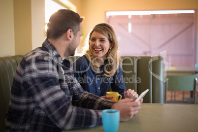 Couple using digital tablet in restaurant