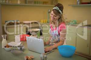 Waitress using laptop in restaurant