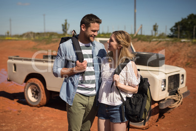 Couple standing together with backpack