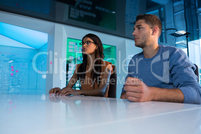 Business executives touching digital screen