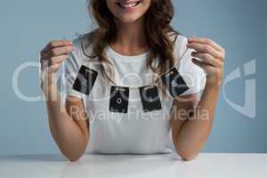 Smiling woman holding card of 2018 against white background