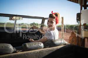 Woman sitting in car on a sunny day