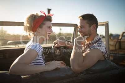 Couple interacting with each other in a car