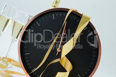 Champagne with clock and glass on white background