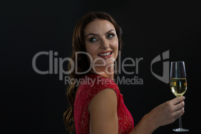 Smiling woman holding glass of champagne