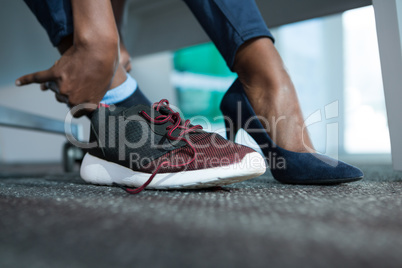 Executive wearing shoes in futuristic office