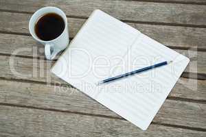 Black coffee with organiser and a pencil