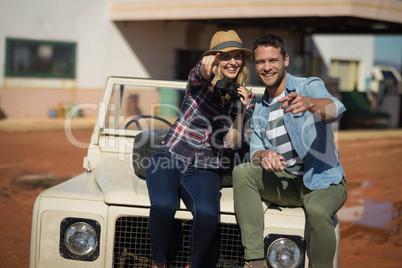 Couple sitting together on a car