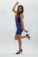 Woman wrapped in multi color streamers posing against white background