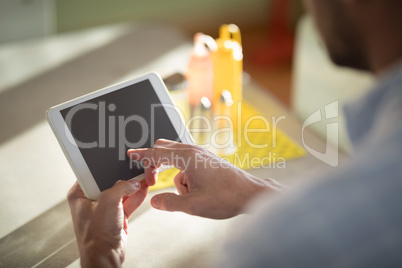 Man using digital tablet in restaurant