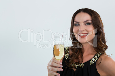 Smiling woman holding glass of champagne