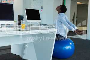 Executive exercising on fitness ball
