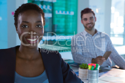 Portrait of confident female executive sitting at desk