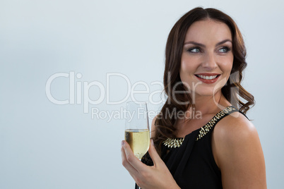 Smiling woman holding glass of champagne