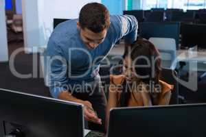 Male and female executive using digital glass sheet