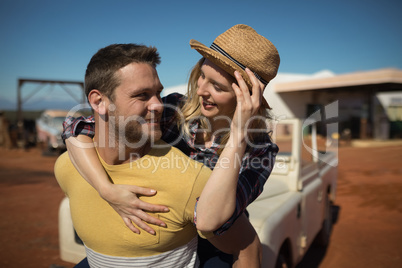 Man giving a piggyback ride to woman