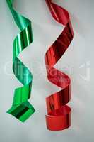 Red and green streamers on white background