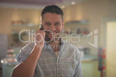 Man talking on mobile phone in restaurant