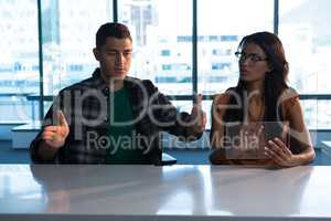Male and female executive using digital invisible screen