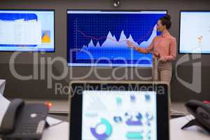 Female executive giving presentation on graph