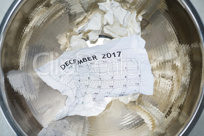 Crumpled calendar in dustbin