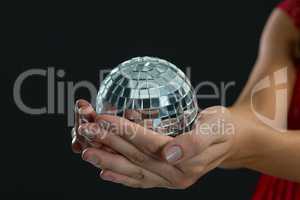 Woman holding mirror ball