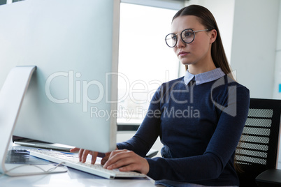 Female executive working on personal computer at desk