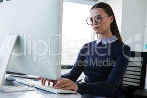 Female executive working on personal computer at desk