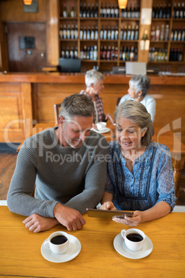 Senior couple interacting while using digital tablet