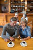 Senior couple interacting while using digital tablet