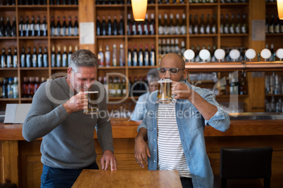 Two men having glass of bear at in restaurant