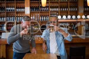 Two men having glass of bear at in restaurant