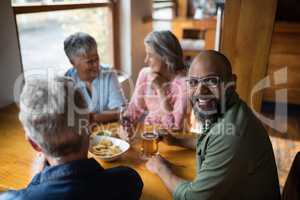 Man having glass of beer with friends in bar